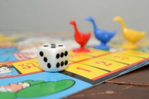 board game with toy ducks and die